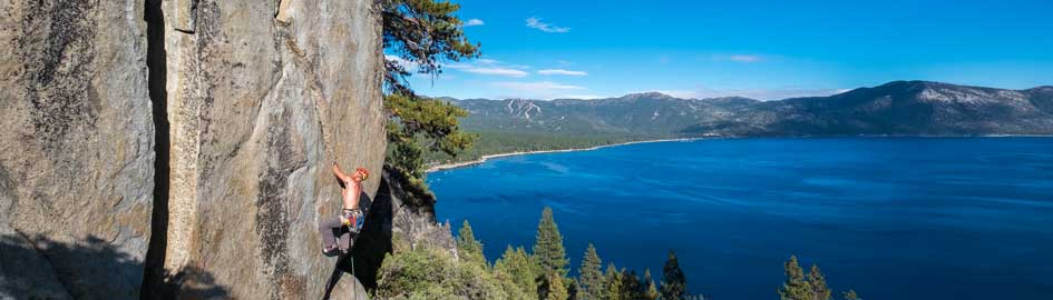 Crack climbing above Lake Tahoe. Crystal Bay boulder.
